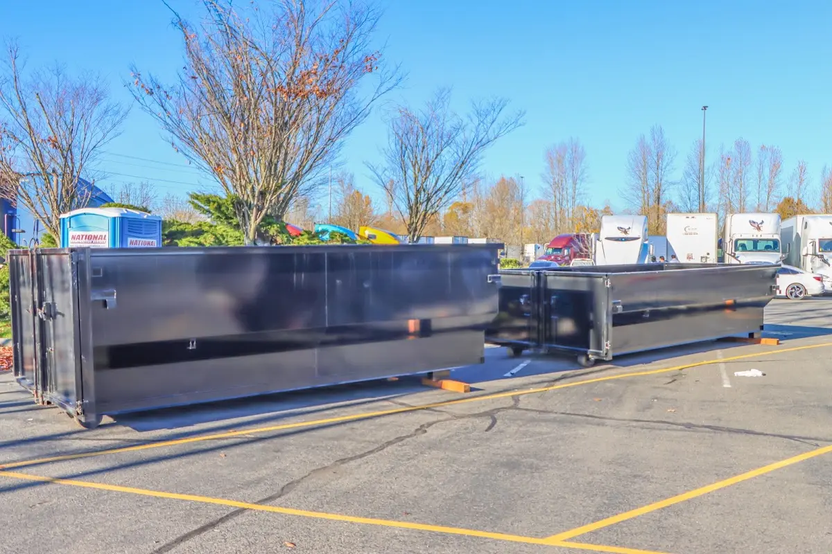 Professional dumpster rental service with roll-off container on residential driveway in South Miami